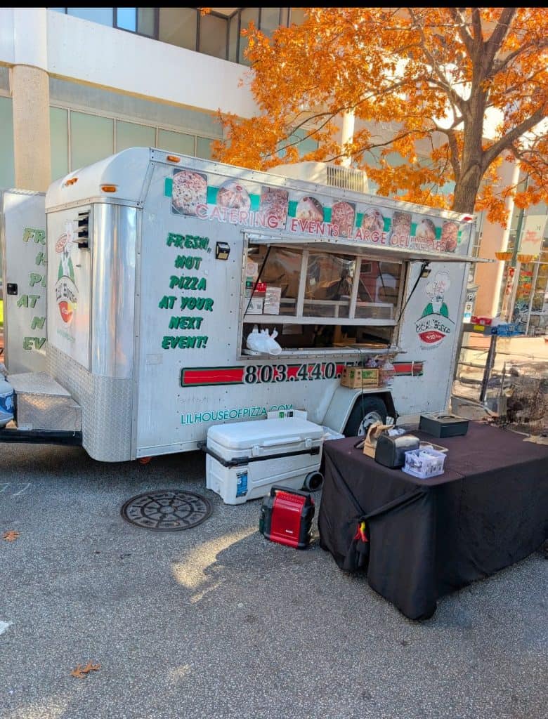 Pizza food truck serving fresh hot pizza at events.