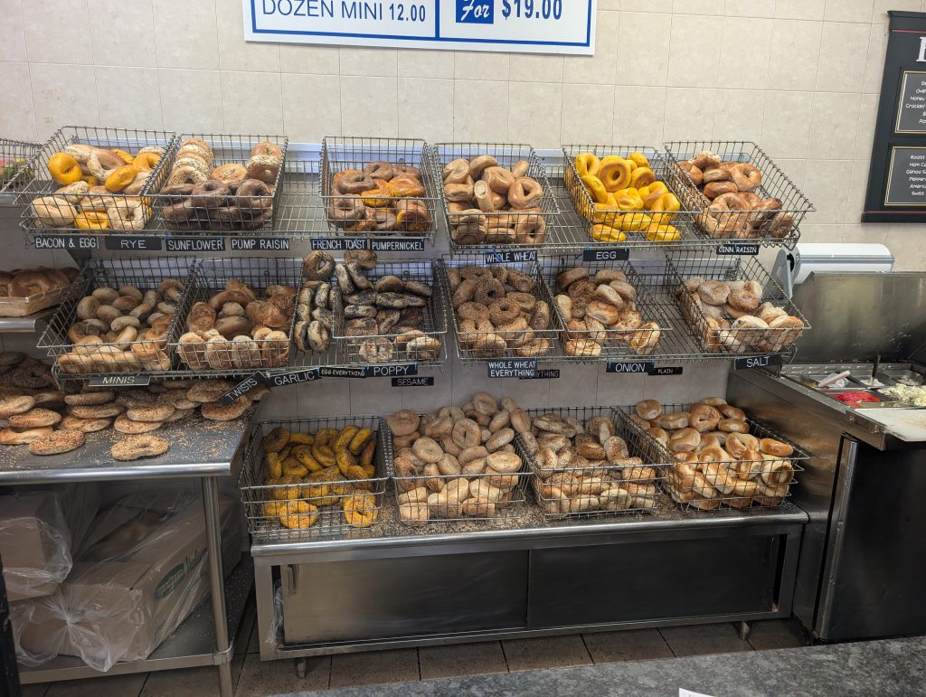 Various types of bagels in stainless steel bagel racks