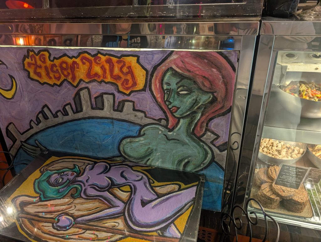 green and purple female figure.